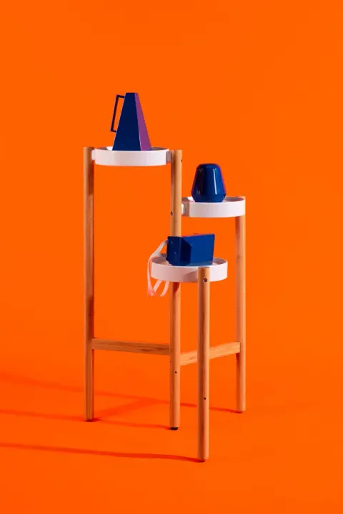 The three objects, mask, megaphone and timer, on a wooden stand