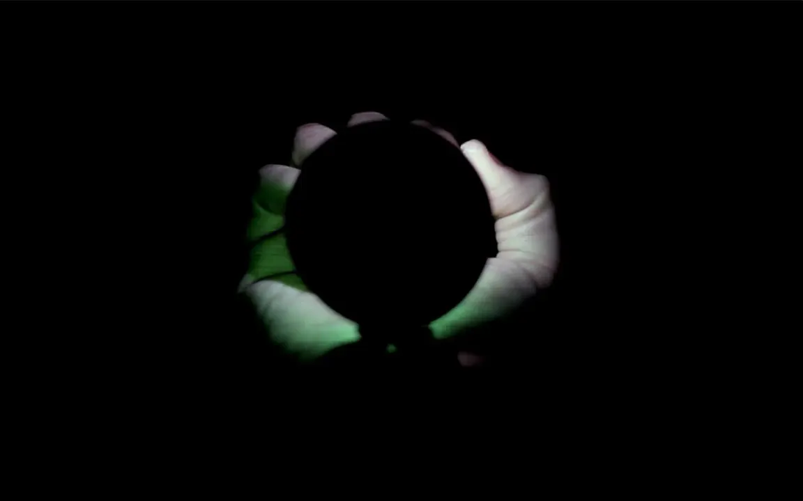 Boone’s LED ring glowing between cupped hands at night