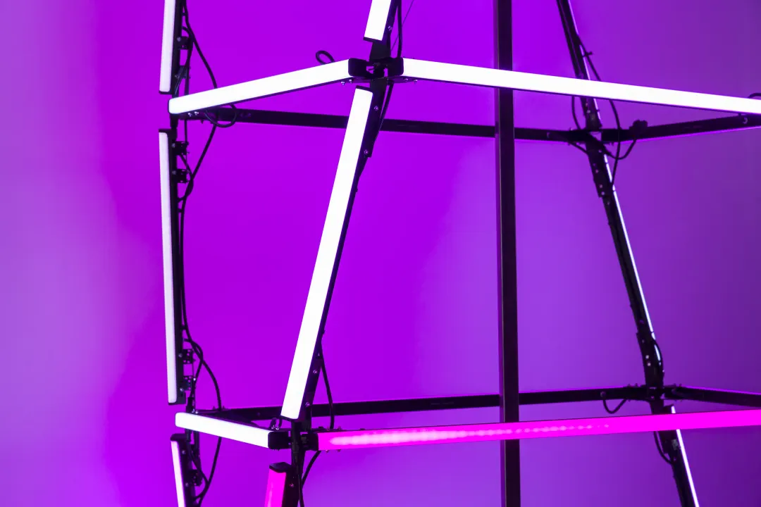 Close-up of a totem’s LED tubes in violet light