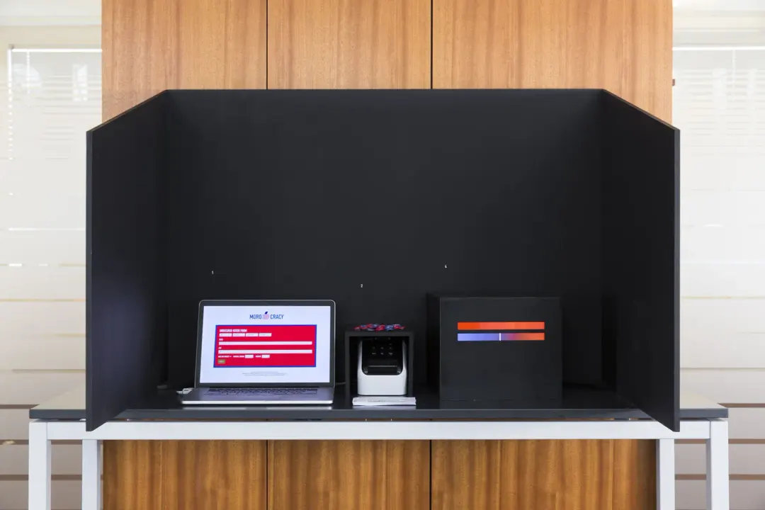 The Morocracy booth: a laptop form, a sticker printer and a ballot box
