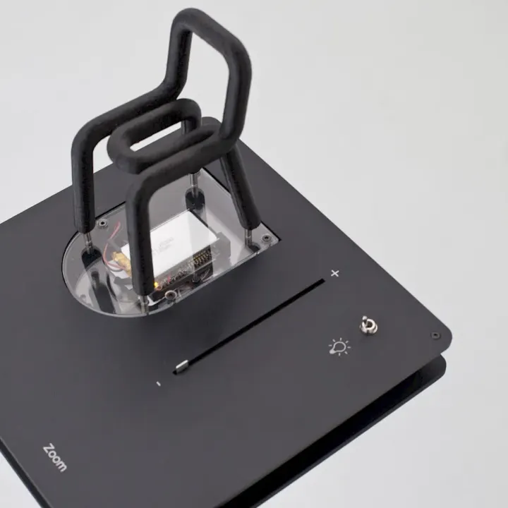 A replica of BIG-GAME’s Bold chair on its base, with a zoom slider and a light switch